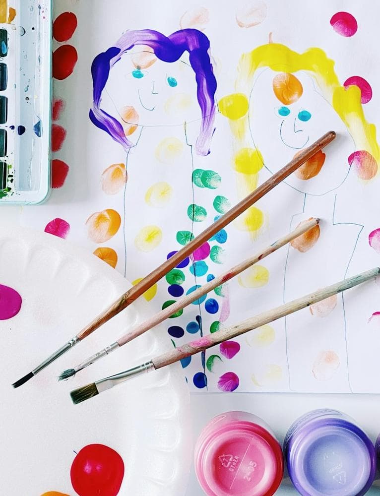 Flower-shaped paint palette with colored pencils