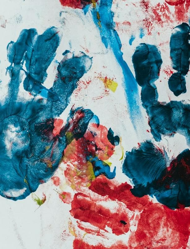 Colorful handprints painted on paper