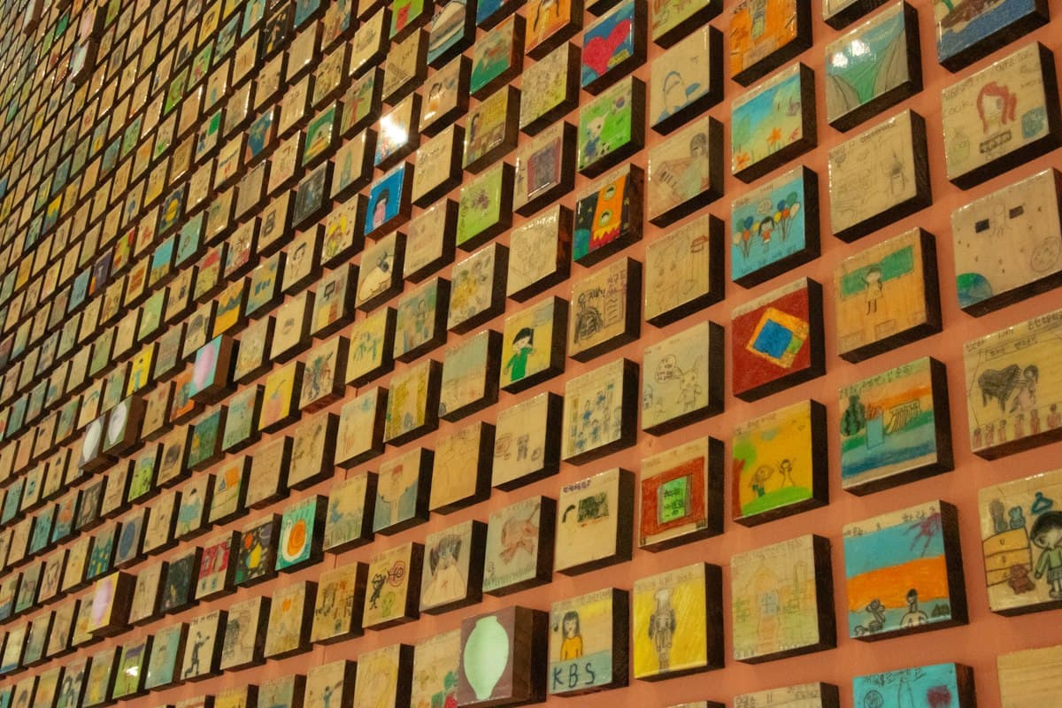 Wall covered in hundreds of small painted tiles