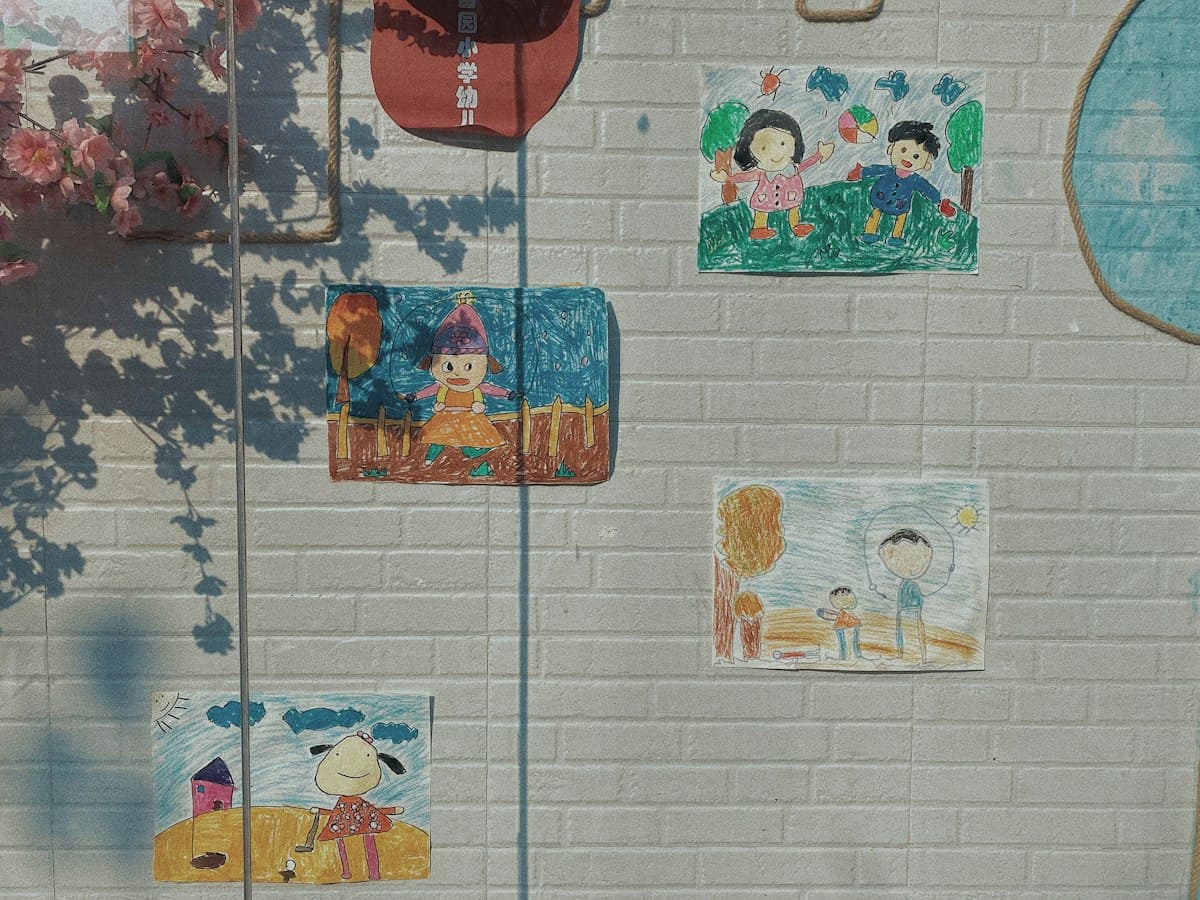 Children's drawings taped to a wall